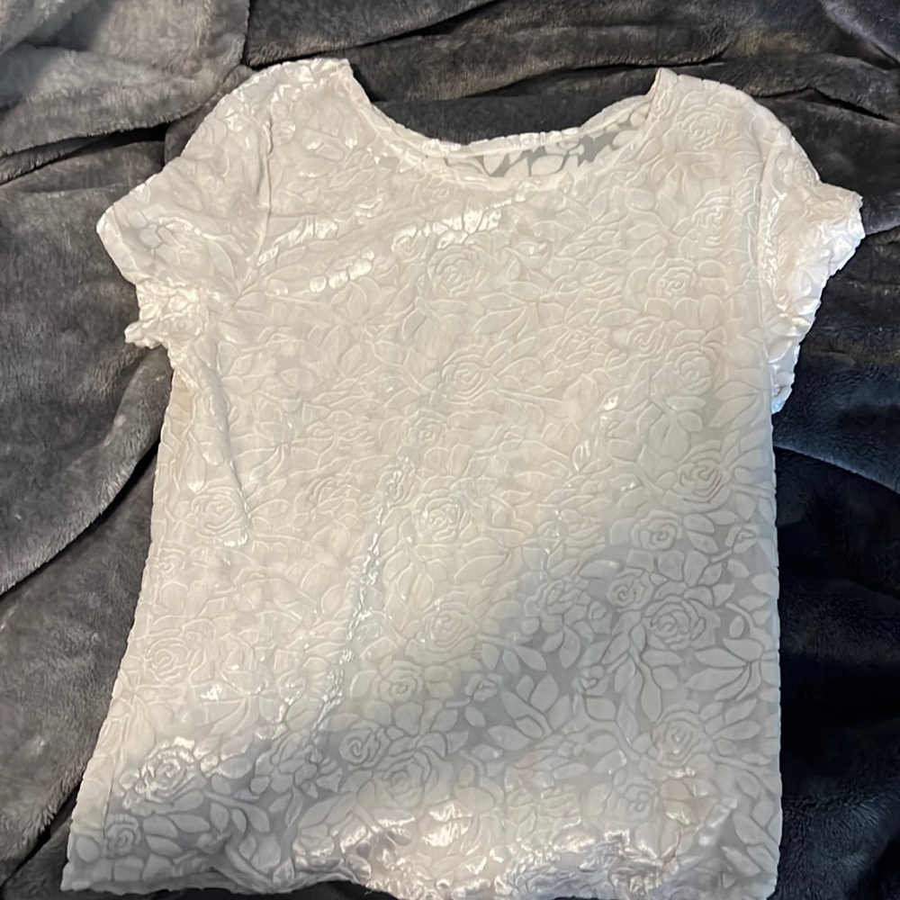 A pretty lace rose detailing white soft velvet type material top